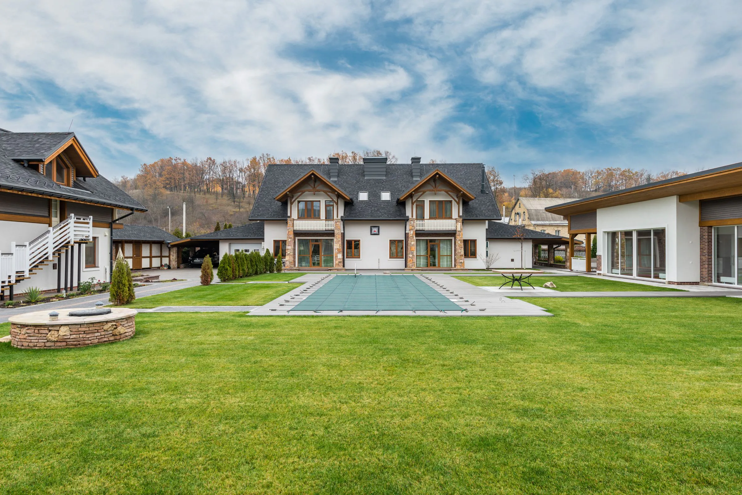 Residential courtyard with a swimming pool, lawns and pitched-roof homes