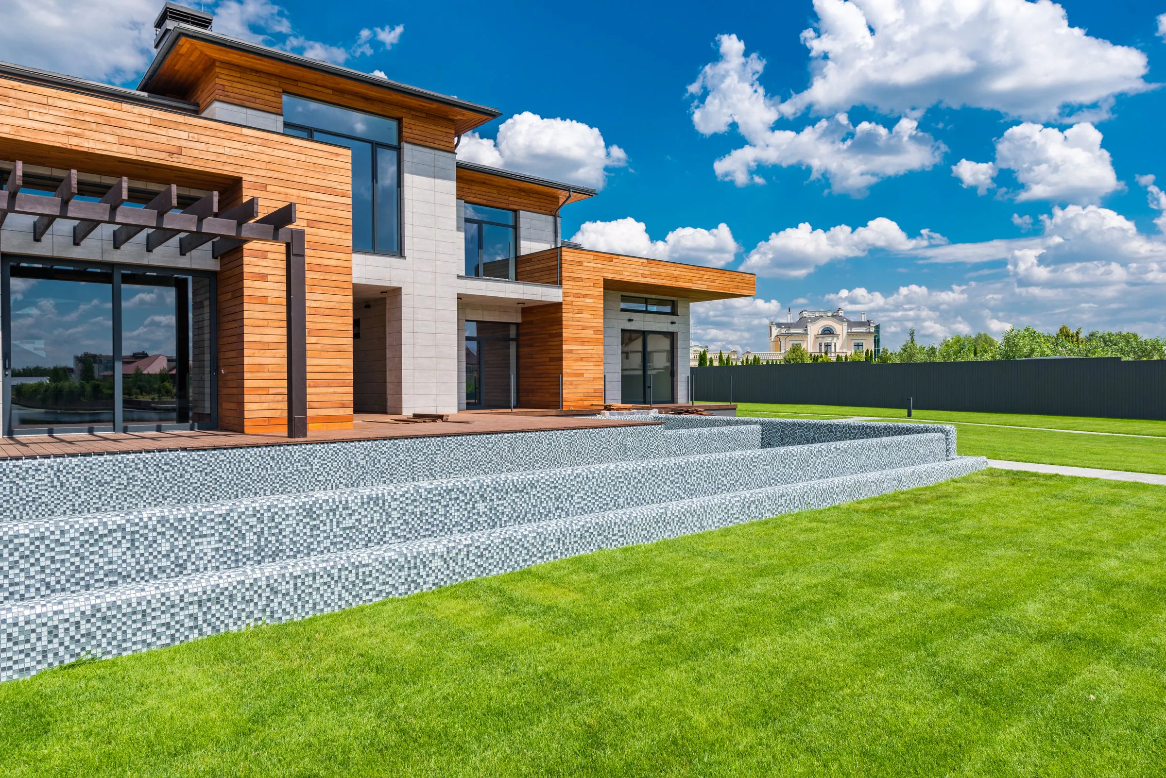 Modern house with full-height glazing, a sheltered terrace and stone paths
